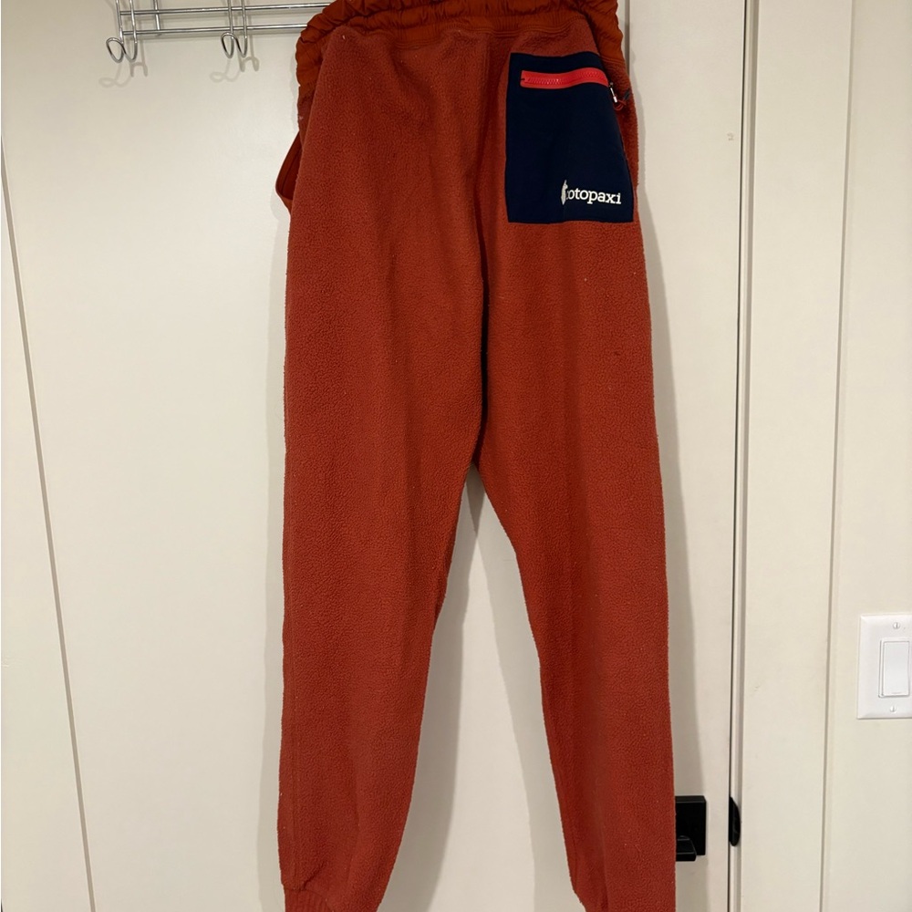 Cotopaxi Rust Fleece Pants with Navy Pocket